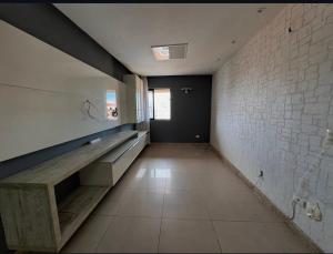 an empty room with a bench and a brick wall at Casa de São Miguel in São Miguel dos Milagres
