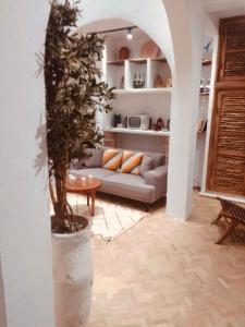 a living room with a couch and a tree at Boho Chic PRIVATE Riad, with Rooftop Ocean view, Fireplace and High speed Internet in Essaouira