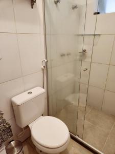 a bathroom with a toilet and a glass shower at Apto Charmoso Santo Antônio in Salvador +4 photos
