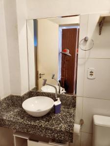 a bathroom with a sink and a toilet on a counter at Apto Charmoso Santo Antônio in Salvador