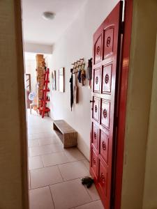 a hallway with a red door and a tiled floor at Apto Charmoso Santo Antônio in Salvador