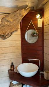 a bathroom with a sink and a tree branch on the wall at TI'BAKOUA in Les Anses-dʼArlets +113 photos