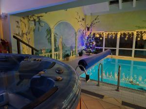 a swimming pool in a house with a christmas tree and a christmas at ZibiSPA pokój nr 3 in Malbork