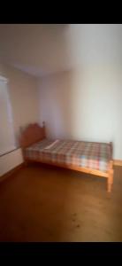 a room with a bed in the corner of a room at Church Bay House in Rathlin Island