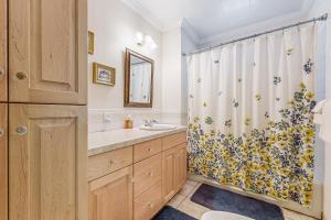 a bathroom with a shower curtain and a sink at Columbia Falls Ranch Living in Columbia Falls +23 photos