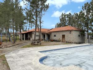 a house with a swimming pool in front of it at Spacious house with mountain view in Vila Fernando in Vila Fernando