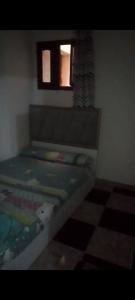 a small bedroom with a bed with a window at for calmness lovers and relax in Alexandria