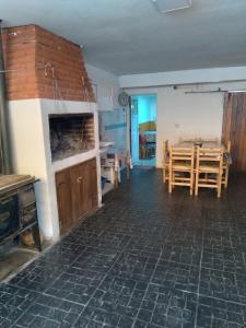 a living room with a table and a dining room at Departamentos Calamuchita in Santa Rosa de Calamuchita