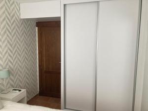a bedroom with a sliding glass closet door with a toilet at Esencia Cazorla in Cazorla
