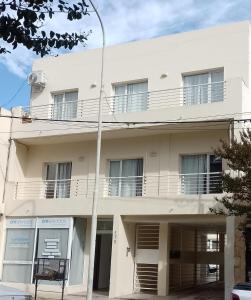 a white building with balconies and a street light at Anita in Tandil