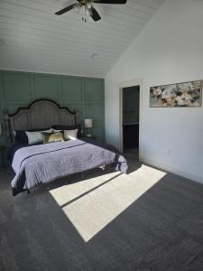 a bedroom with a bed and a ceiling fan at Sky Sapphire Haven in Fish Haven