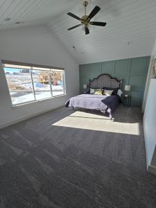 a bedroom with a bed and a ceiling fan at Sky Sapphire Haven in Fish Haven