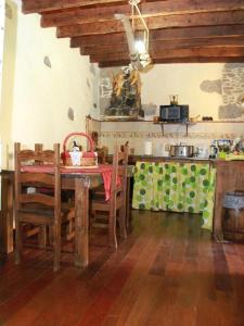 a kitchen with a table and chairs and a kitchen with a counter at Casa Emblemática La Pileta in Agüimes