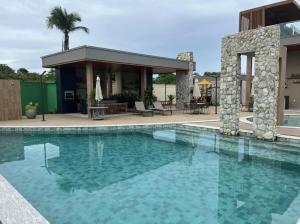 a swimming pool in front of a house at Sunny Kite House Prea in Prea