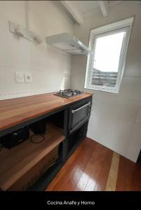a small kitchen with a counter and a window at Casa Gaia in La Paloma