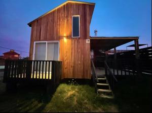 a small wooden house with a staircase leading to it at Casa Gaia in La Paloma