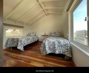 a bedroom with two beds and a window at Casa Gaia in La Paloma +13 photos