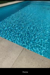 a blue swimming pool with blue water at Casa Gaia in La Paloma
