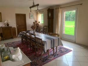 a dining room with a table and some chairs at Pressoir du bois gribout in Hautot-Saint-Sulpice