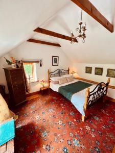 a bedroom with a bed and a red carpet at The Limehouse Cottage in Killybegs