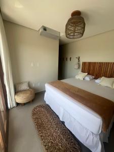 a bedroom with a large bed and a chair at Sunny Kite House Prea in Prea +25 photos