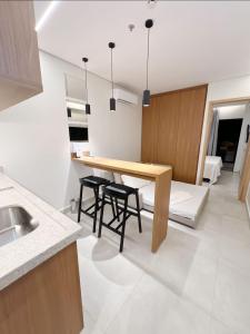 a kitchen with a wooden table and some chairs at Apto Premium Resort in Salinópolis