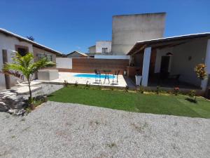 マリカーにあるCabana de férias Itaipuaçuのスイミングプール付きの家屋裏庭 +7枚の写真