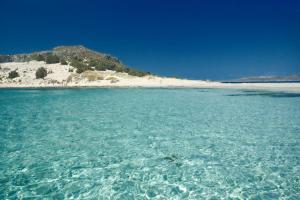 a large body of water with a beach in the background at Simosmare Resort in Elafonisos
