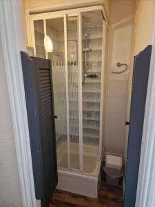 a shower with a glass door in a bathroom at Winston House Guesthouse in Bridlington
