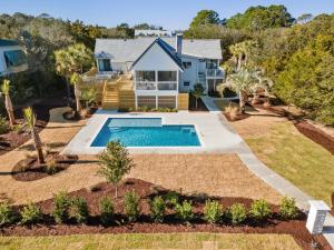 a house with a swimming pool in a yard at High Seas in DeBordieu Colony home by Peace Vacations in Georgetown