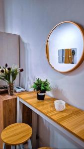 a mirror on a wall next to a wooden counter at Getaway Gem in the City - Ann's Residences in Lapu Lapu City