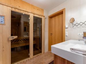 un bagno con un lavandino bianco e una doccia di Chalet Vorderjausern a Saalbach Hinterglemm Altre 26 foto