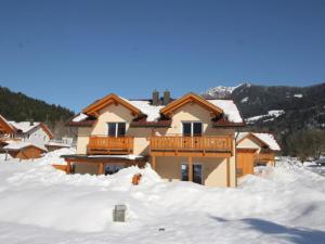 a house in the snow with snow around it at Chalet am Sonnenpiste in Kötschach