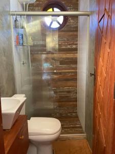 a bathroom with a shower with a toilet and a sink at Casa de Praia Itacimirim Bahia - Piscina e Conforto in Camacari +14 photos
