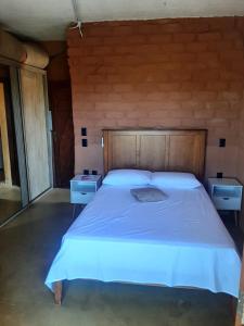a bedroom with a large bed with two night stands at Casa de Praia Itacimirim Bahia - Piscina e Conforto in Camacari