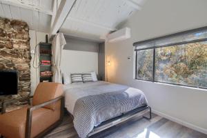 a small bedroom with a bed and a window at Waterfall House-Riverfront-Bbq-sleeps Four in Oakhurst