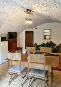 a living room with a table and a couch at Maison de charme avec piscine partagée à Saint-Julien-de-la-Nef in Saint-Julien-de-la-Nef