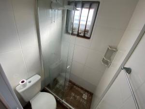 a small bathroom with a toilet and a shower at The Box Container House casa oceano in Imbituba +14 photos