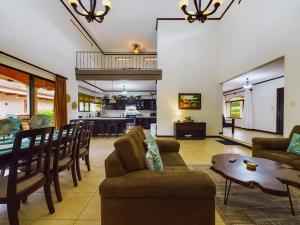 a living room with a couch and a table at Catalina Cove 3- 6 Bedroomloft Home in Brasilito