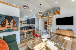 a living room with a tv and a couch and a table at Remote Home with Deck and Grill in Scenic Tuckasegee! in Tuckasegee