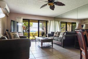 a living room with couches and a ceiling fan at Kihei Akahi A104 in Wailea