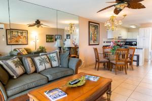 a living room with a couch and a table at Kihei Akahi A104 in Wailea