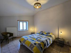 a bedroom with a bed and a window and a lamp at Gîte de charme en campagne, 5-8 pers., cheminée, nature, proche Pilat, activités à proximité - FR-1-582-269 in Saint-Romain-Lachalm +3 photos