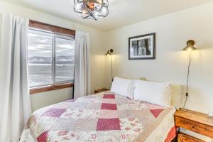 a bedroom with a bed and a large window at Starry Skies and Mtn Views Family Retreat in Elmo in Dayton