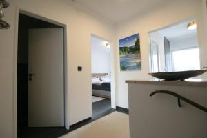 a bathroom with a sink and a mirror at Ferienhaus LebensART in Bischofswiesen