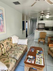 a living room with a couch and a table at Dee's Dream Sunset Condo - #151 in Key West