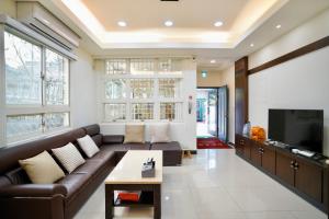 a living room with a couch and a tv at 金華民宿 in Jincheng