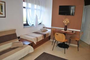 a bedroom with two beds and a desk and a television at Villa in Brenna near Ski Lifts in Brenna