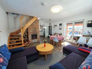a living room with a couch and a table and a fireplace at House near S owi ski Park and Sandy Beach in Smołdzino
