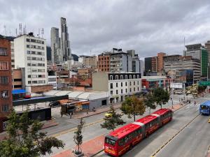 two red buses on a street in a city at Hotel HILLS BOGOTA in Bogotá +30 photos